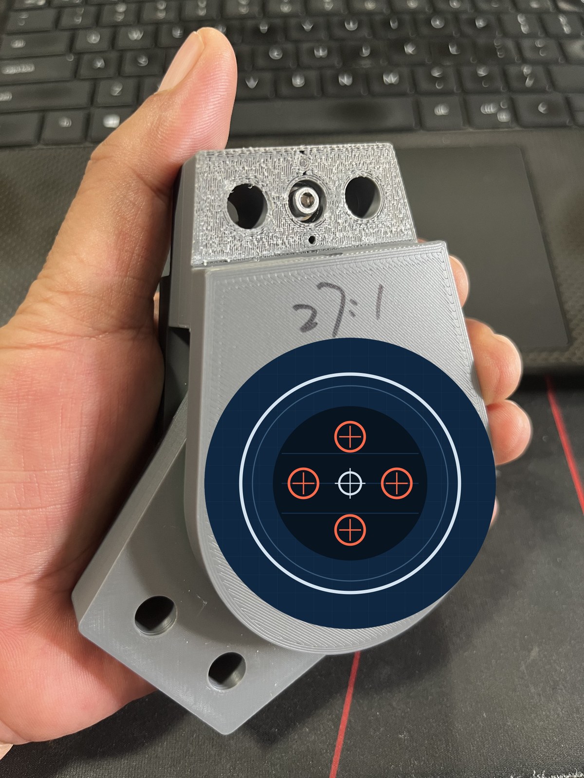 A 3D-printed ASDrive Ø50 prototype held in one hand, ratio 27:1, with the working core masked.